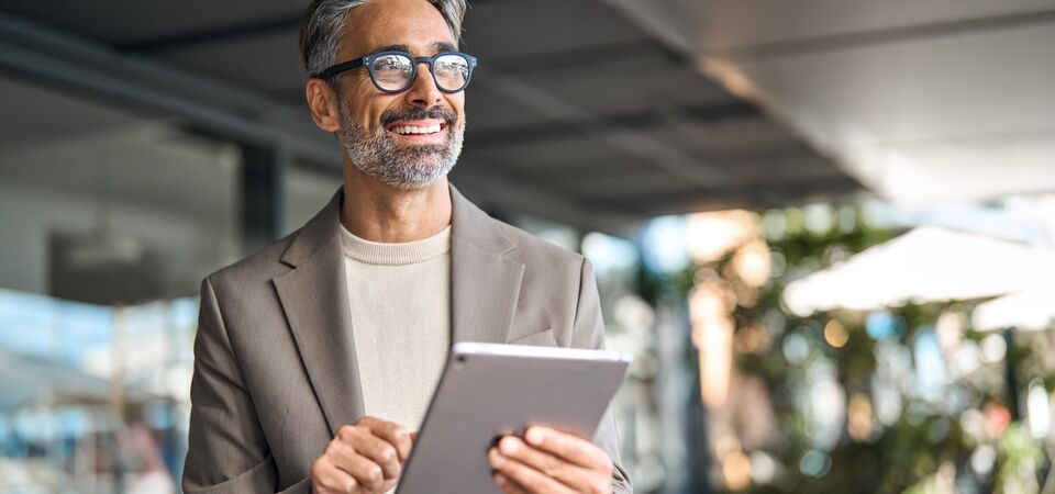 COLOUR IMAGE_businessman_on_tablet_Jun26