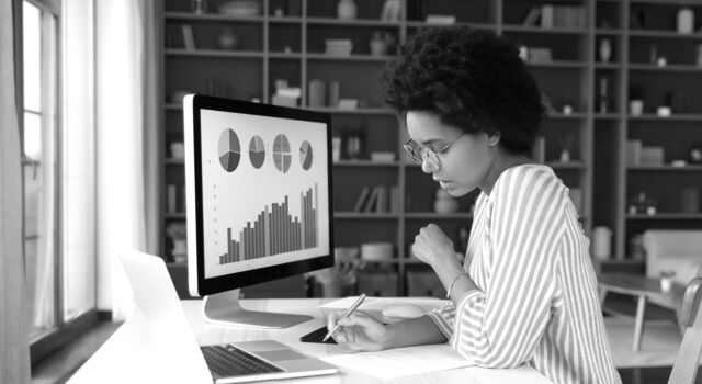 SINGLE-IMAGE_concentrated-young-african-american-woman-working-desktop_may24