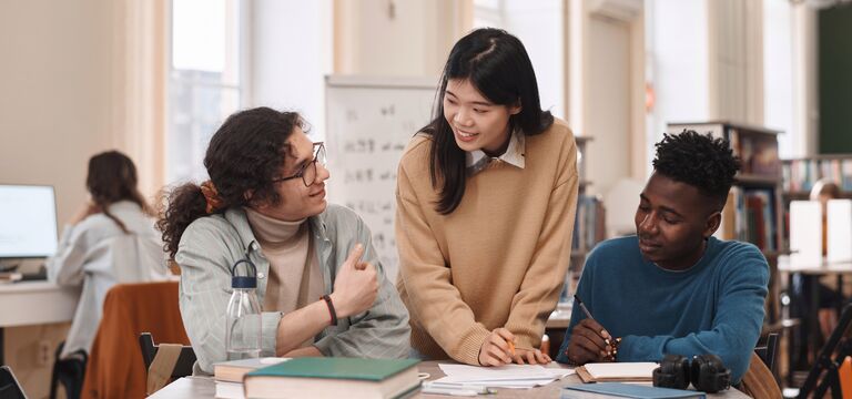 COLOUR-IMAGE_three-students-working-together-in-library_apr26