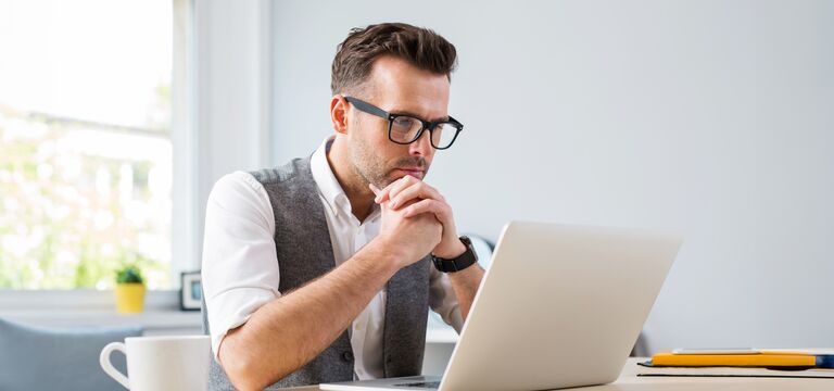 /bynder-asset/bynder:25FB1CCC-E9D3-44A7-A1A25BF9B54D76A4/Landscape_MD/COLOUR-IMAGE_Man_glasses_working_laptop_home_july26.jpg?1782911749000