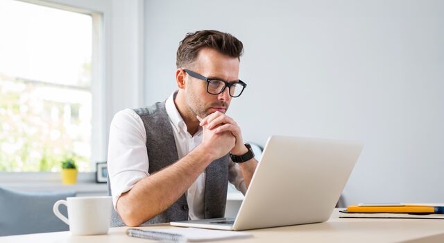 COLOUR-IMAGE_Man_glasses_working_laptop_home_july26