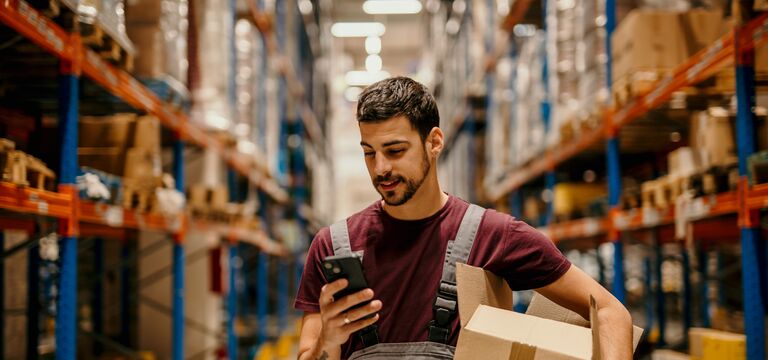 /bynder-asset/bynder:2C63D4B4-C62F-4EEC-93AC13FE9A578B0A/Landscape_MD/COLOUR-IMAGE_male-warehouse-worker-working-looking-at-mobile-phone_jul26.jpg?1784550814000