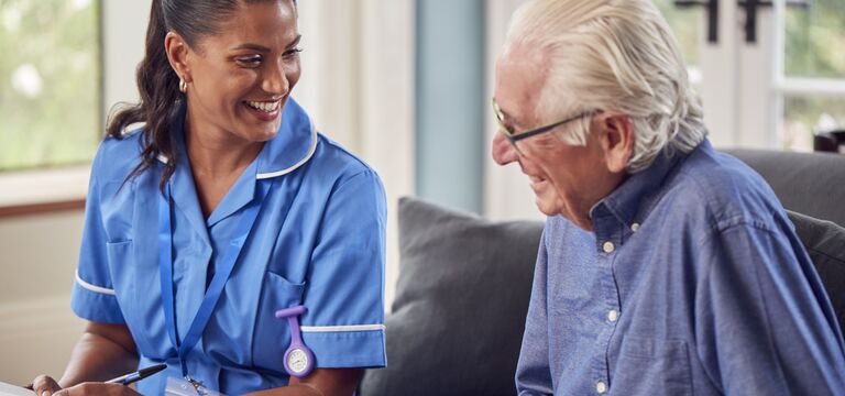 COLOUR-IMAGE_Man_Talking_Female_Nurse_Care_Worker_June26