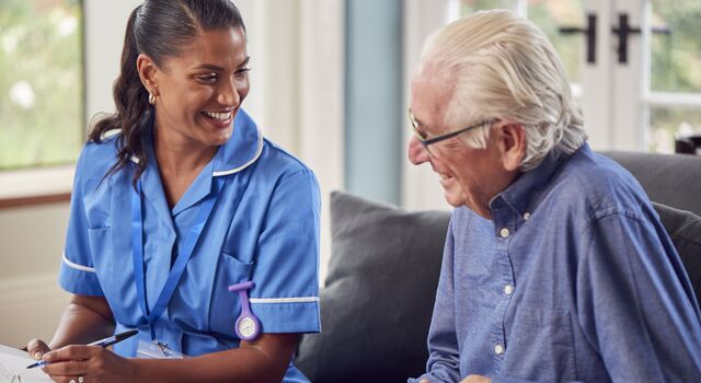 COLOUR-IMAGE_Man_Talking_Female_Nurse_Care_Worker_June26