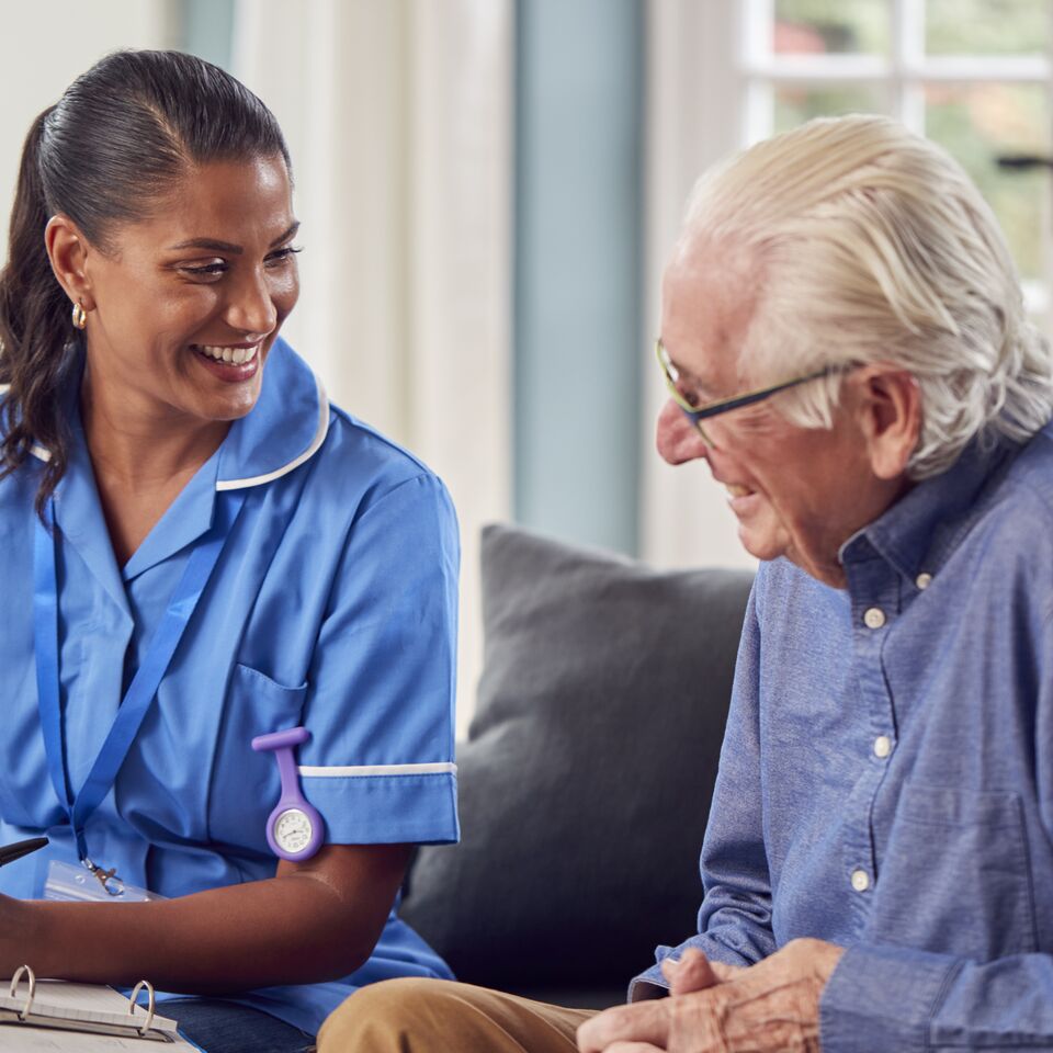 COLOUR-IMAGE_Man_Talking_Female_Nurse_Care_Worker_June26
