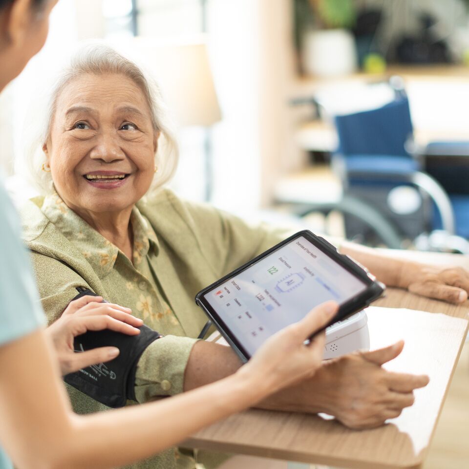 COLOUR-IMAGE_healthcare-nurse-patient-blood-pressure-machine-tablet_feb26