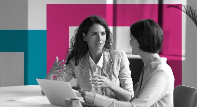 SINGLE-IMAGE_squares-two-business-women-sit-at-desk-laptop_may24