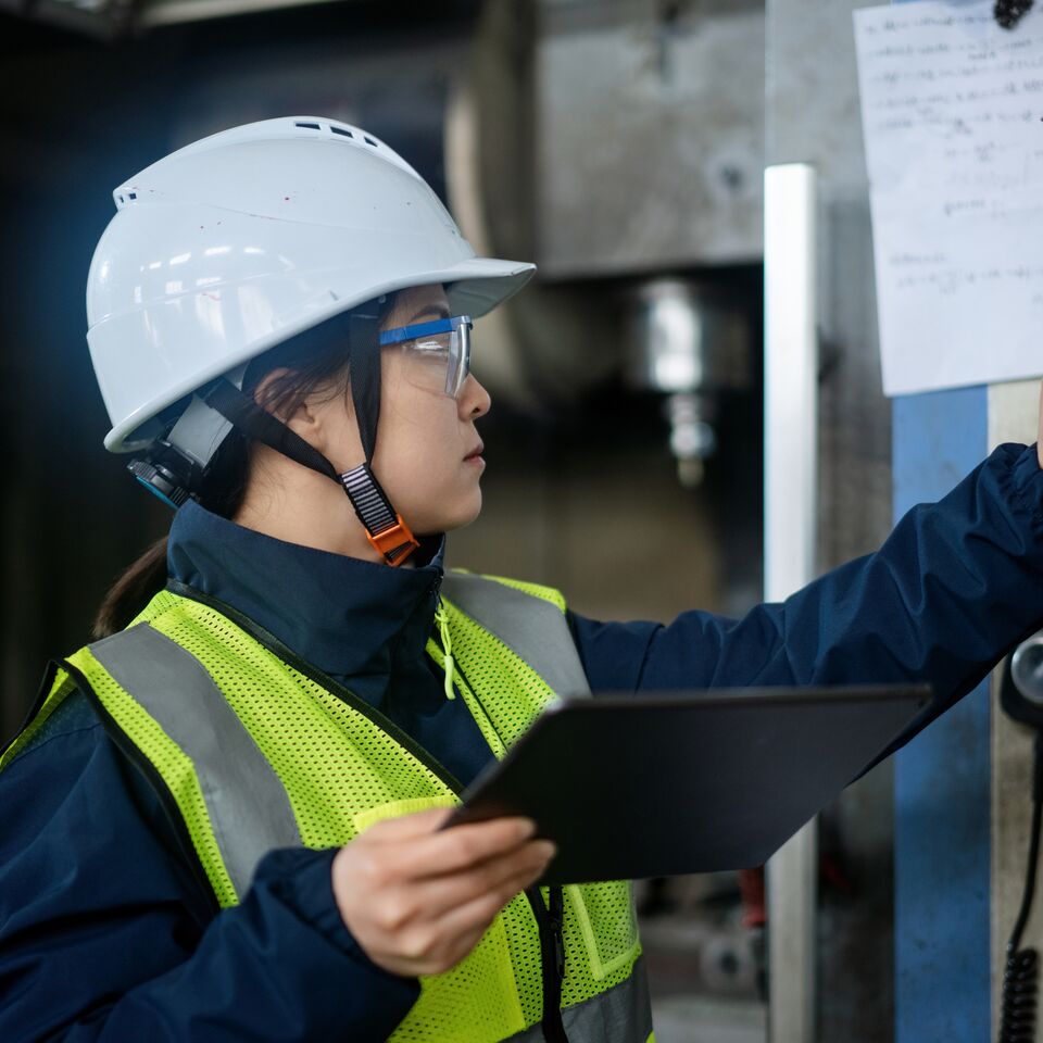 COLOUR-IMAGE_woman-pressing-buttons-on-keypad-in-factory_apr26