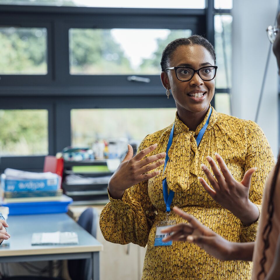 COLOUR-IMAGE_female-teacher-speaking-to-two-students_apr26