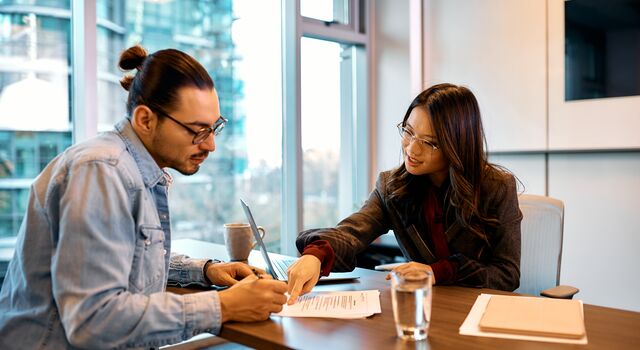 COLOUR-IMAGE_man-and-woman-reading-through-documents_jul26