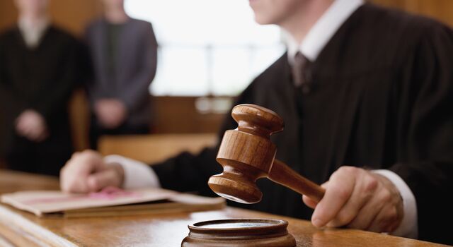 COLOUR-IMAGE_male-judge-holding-gavel_feb26