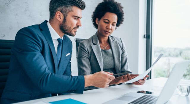 COLOUR-IMAGE_man-and-woman-looking-over-documents-together_jul26