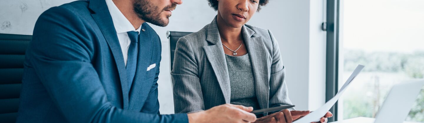 COLOUR-IMAGE_man-and-woman-looking-over-documents-together_jul26