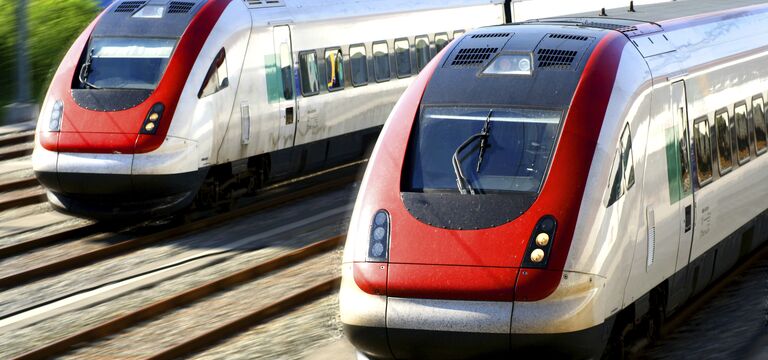 /bynder-asset/bynder:78697A38-84EC-43AA-98B0BFCA6D1671F9/Landscape_MD/COLOUR-IMAGE_two-red-and-grey-trains-travelling-on-tracks_feb26.jpg?1773752975000
