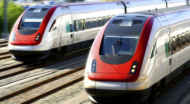 COLOUR-IMAGE_two-red-and-grey-trains-travelling-on-tracks_feb26
