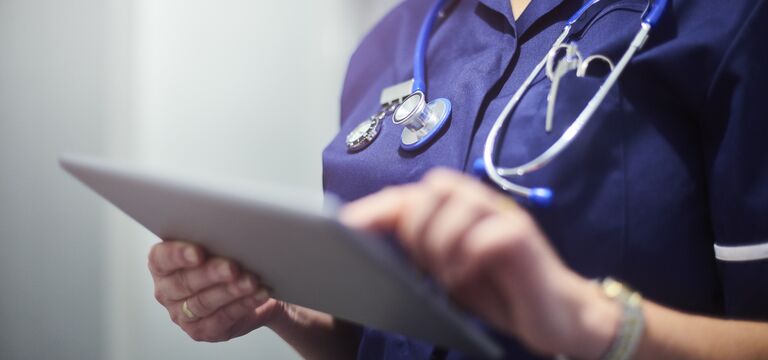 /bynder-asset/bynder:822406AD-6585-41CD-A8D132754289A82F/Landscape_MD/COLOUR-IMAGE_Nurse_using_digital_tablet_June26.jpg?1781694477000