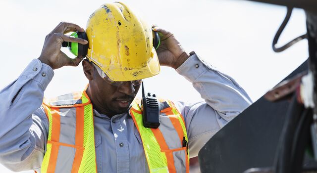 COLOUR-IMAGE_construction-worker-taking-off-ear-protection_jun26