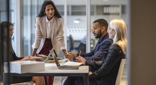 COLOUR-IMAGE_four-professionals-in-business-meeting_jul26