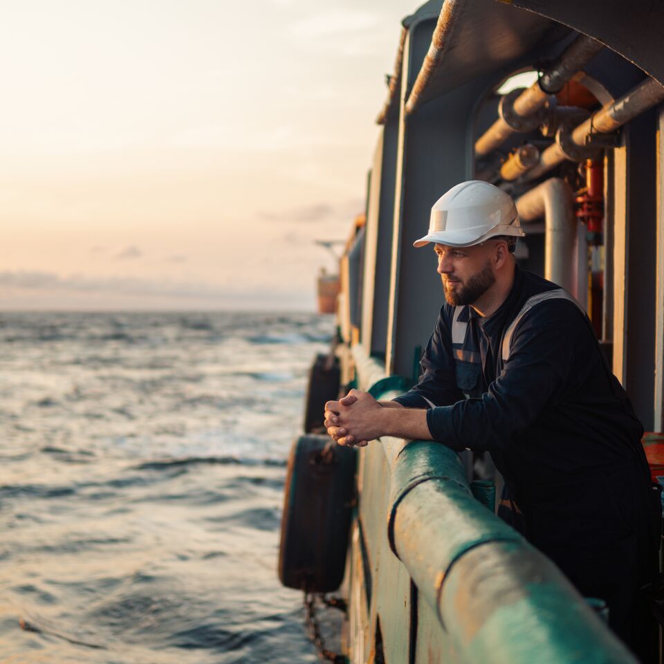 COLOUR-IMAGE_maritime-worker-on-boat-looking-to-sea_mar26