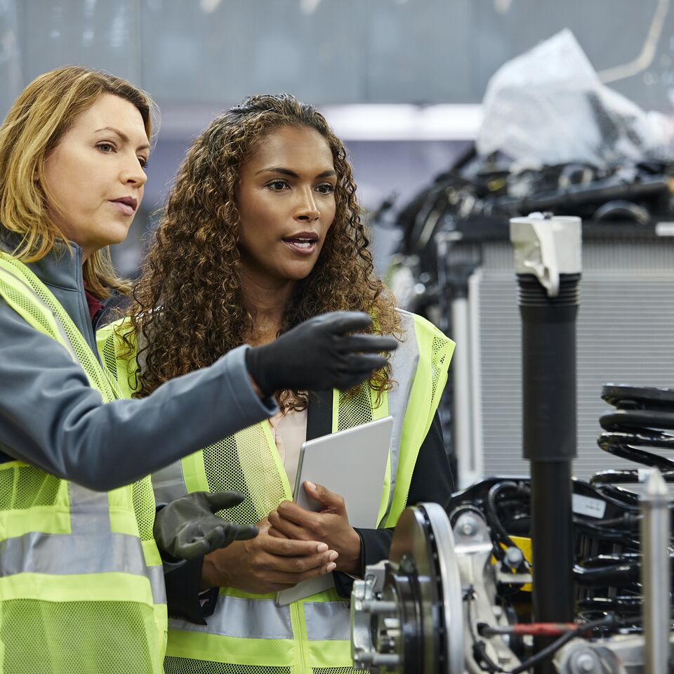 COLOUR-IMAGE_two-ladies-speaking-next-to-a-machine_apr26