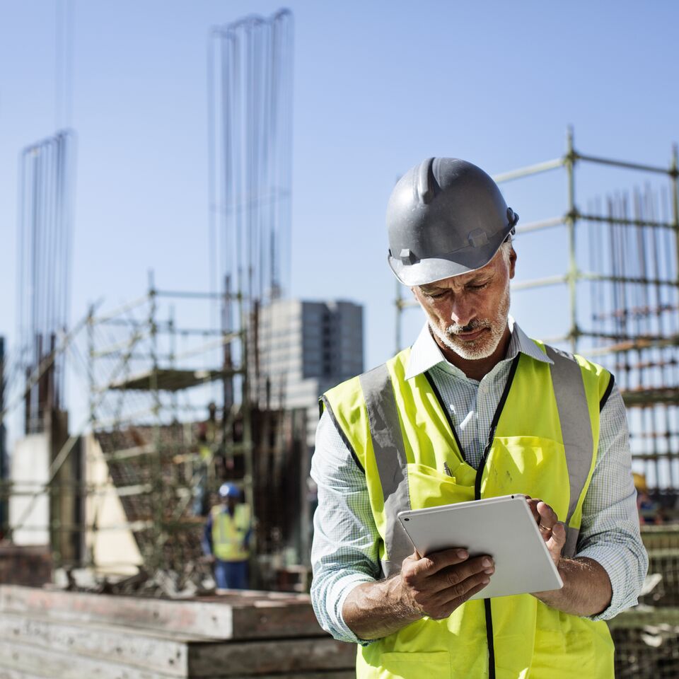 COLOUR-IMAGE_construction-manager-architect-using-tablet-on-site_jul26
