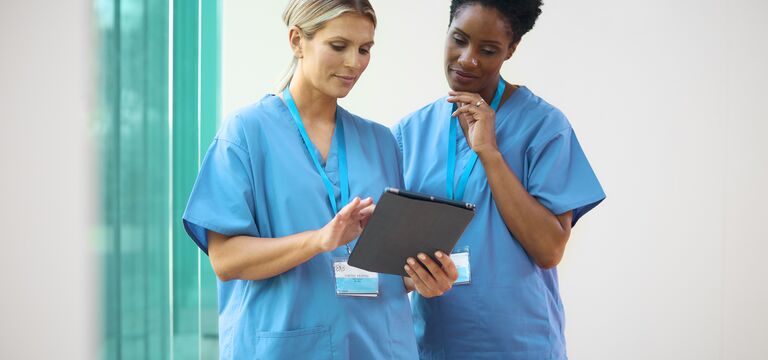 /bynder-asset/bynder:9C34AF81-1C56-4177-A17715413169BFF4/Landscape_MD/COLOUR-IMAGE_two-female-nurses-with-lanyards-looking-at-tablet-screen_apr26.jpg?1777555299000