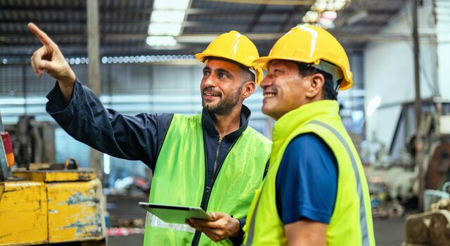 COLOUR-IMAGE_two-men-looking-at-fixture-in-factory_apr26