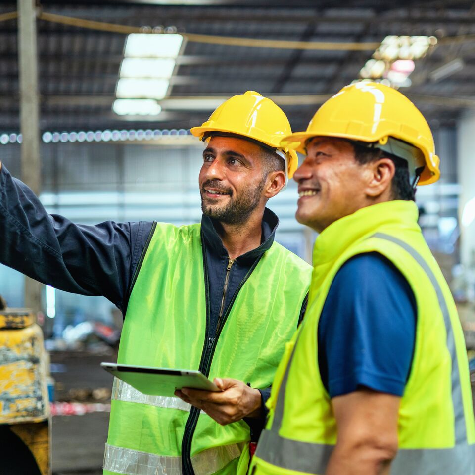 COLOUR-IMAGE_two-men-looking-at-fixture-in-factory_apr26