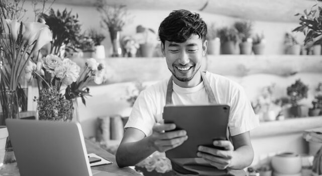 SINGLE-IMAGE_flower-shop-owner-checks-tablet_aug25