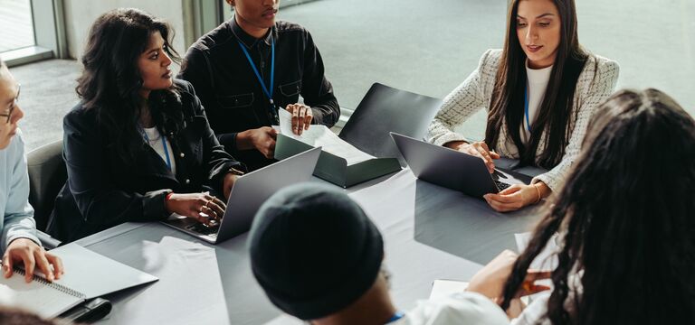 /bynder-asset/bynder:AB803680-8991-4EB3-874EF9EE9E05328E/Landscape_MD/COLOUR-IMAGE_six-professionals-discussing-with-laptops-on-their-table_jul26.jpg?1782917094000