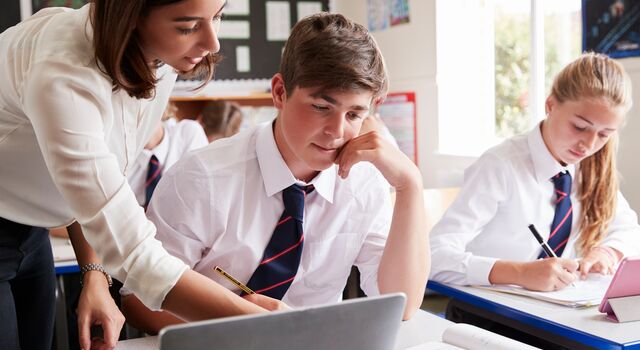 COLOUR-IMAGE-teacher helping boy highschool-feb26