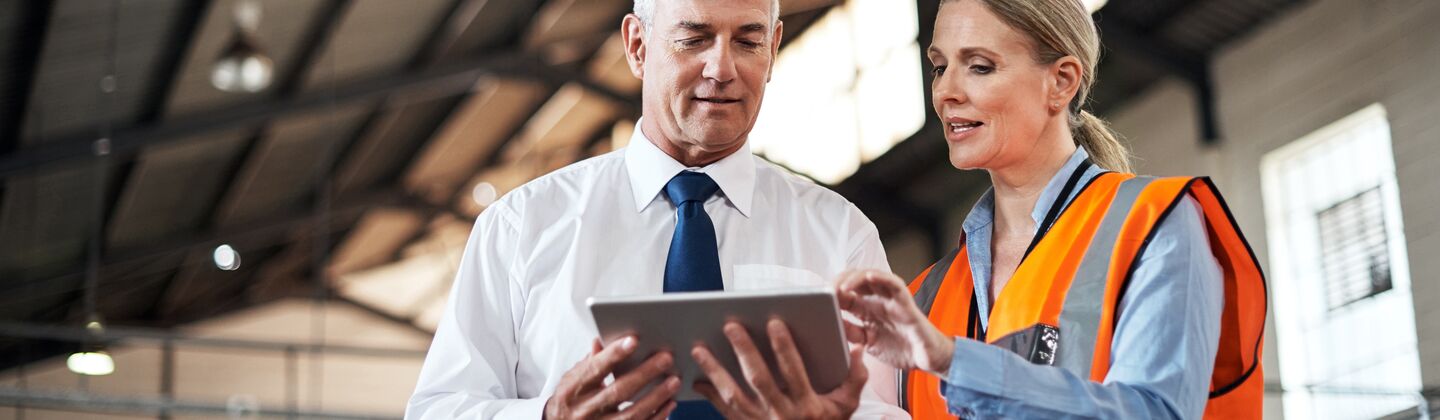COLOUR-IMAGE_two-colleagues-speaking-over-a-tablet_apr26