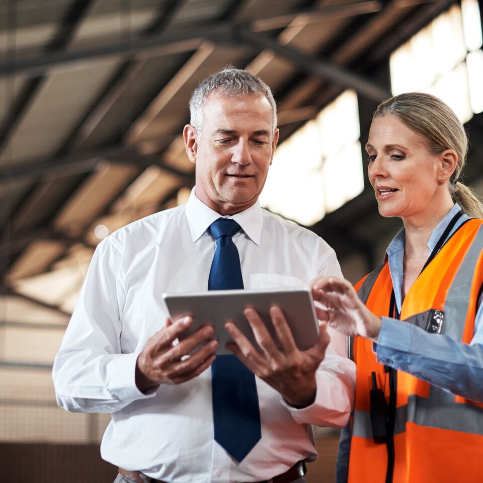 COLOUR-IMAGE_two-colleagues-speaking-over-a-tablet_apr26