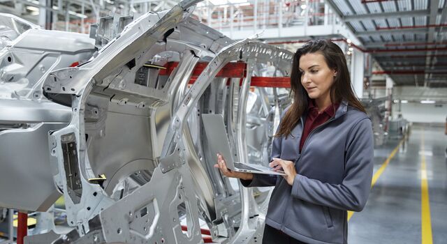 COLOUR-IMAGE_automotive-factory-floor-site-manager-inspecting-quality-looking-at-laptop_sep26