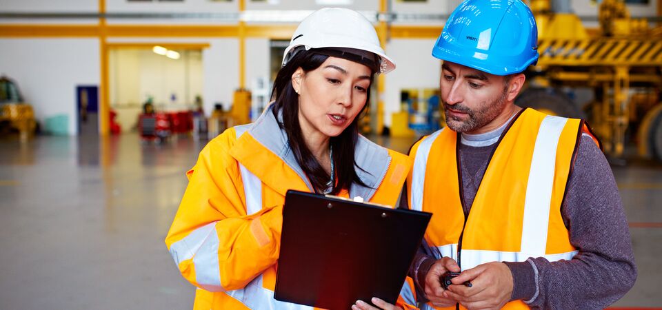 COLOUR-IMAGE_two-colleagues-looking-at-a-clipboard_apr26