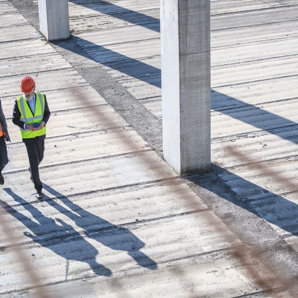 COLOUR-IMAGE_two-contstruction-workers-walking_feb26