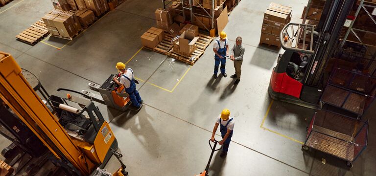 COLOUR-IMAGE_workers-and-forklift-working-in-indsutrial-warehouse-approaching-hazard_jul26