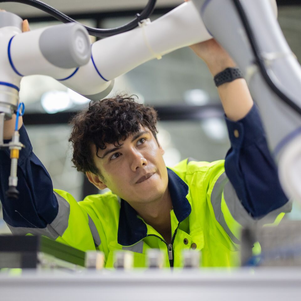 COLOUR-IMAGE_automotive-Male engineer-inspecting-car-manufacturing-robot_feb26