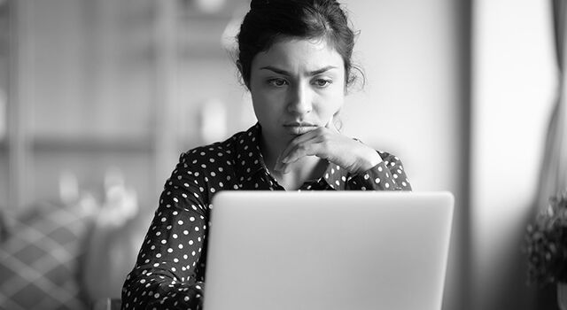 SINGLE-IMAGE_serious-frowning-indian-woman-read-email-on-laptop_jul25