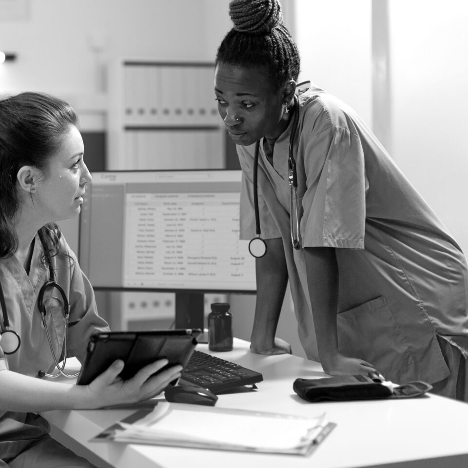 SINGLE-IMAGE_two-nurses-talking-over-tablet_sept24
