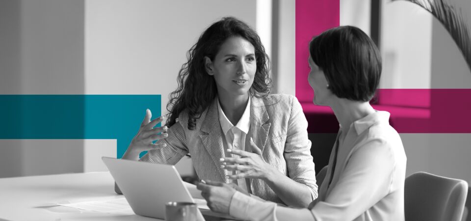 SINGLE-IMAGE_squares-two-business-women-sit-at-desk-laptop_jul24